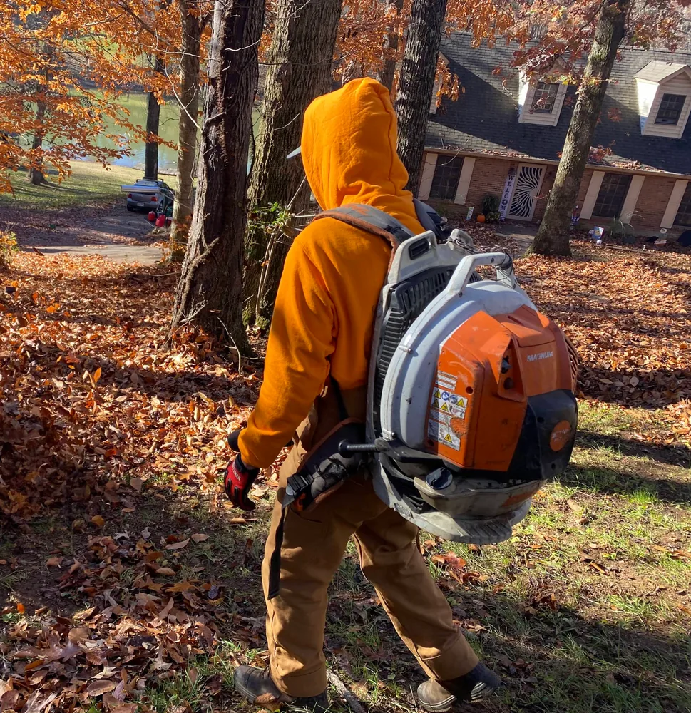 3R Outdoor crew member clearing leaves with a backpack blower