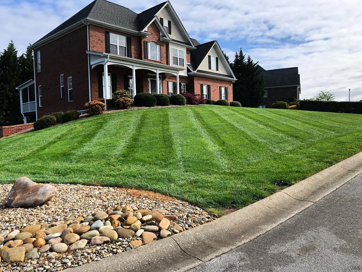 Green lawn and refreshed landscape beds at a Morristown home