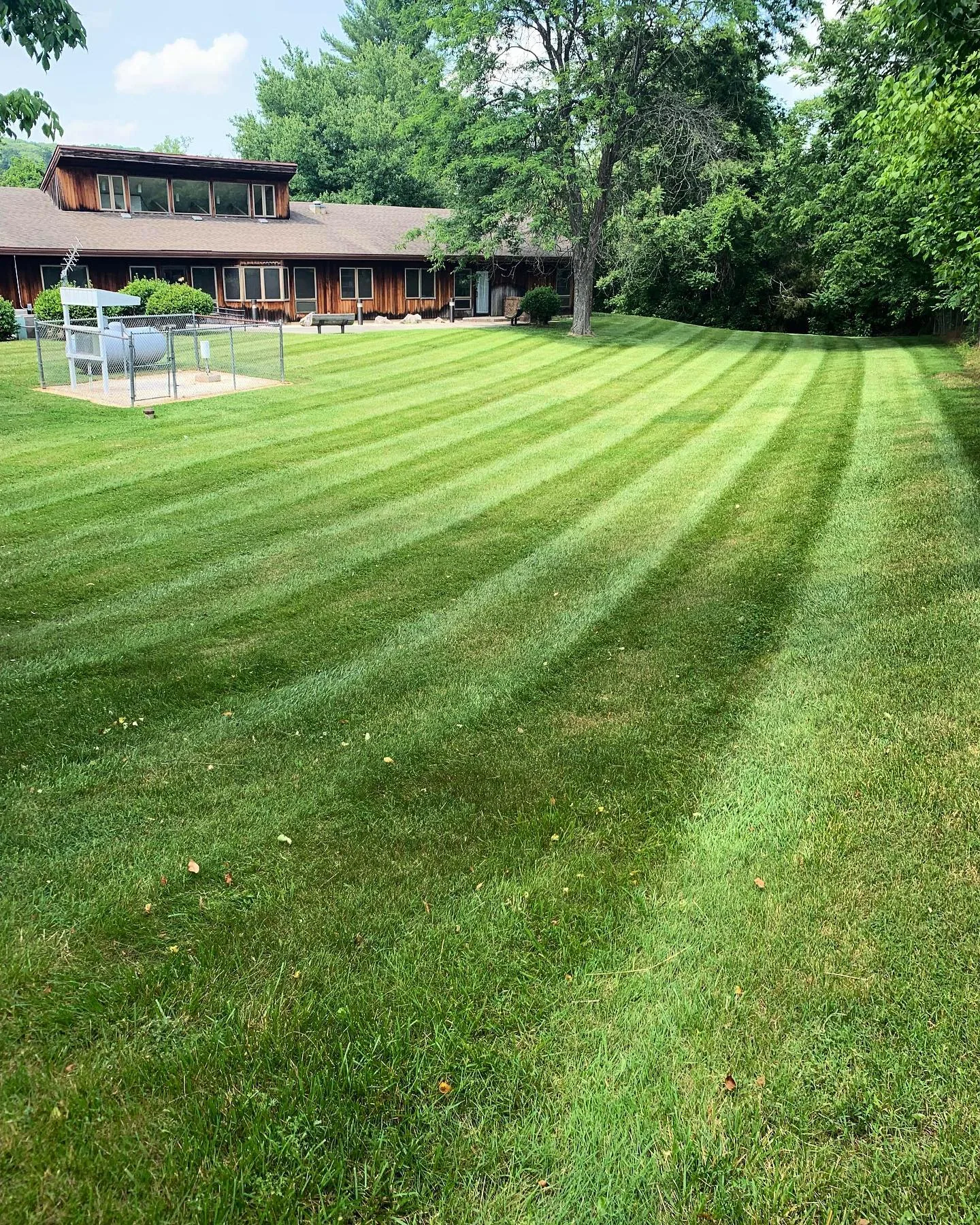 Freshly striped lawn after mowing and edge trimming by 3R Outdoor